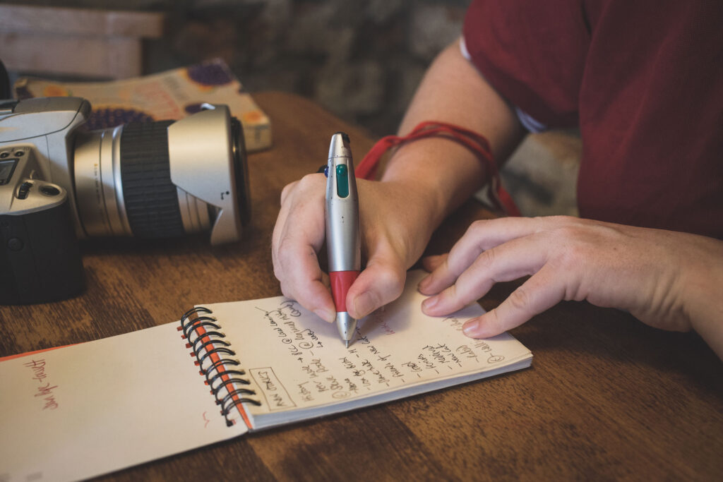 Sarah, writing in a notebook